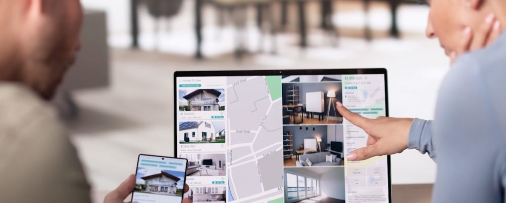 An image of a couple at home looking at property listings on a laptop.
